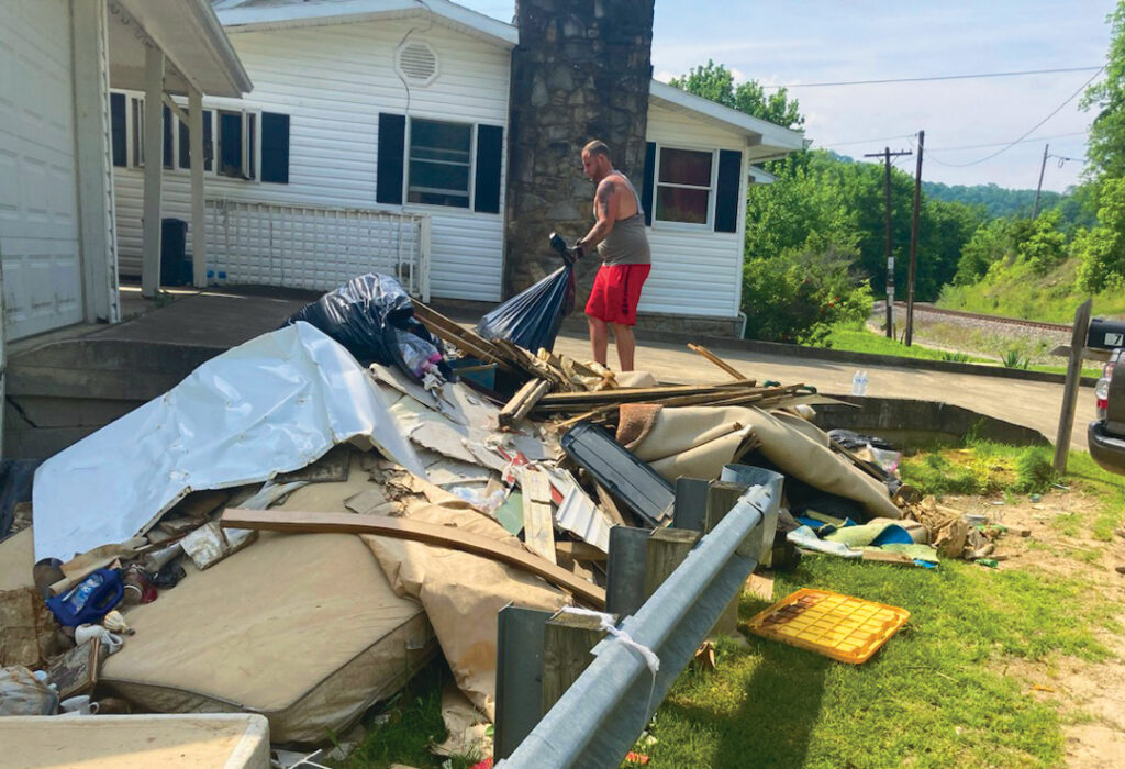 Man from Kentucky Colonels Good Works Program cleaning up after tornado