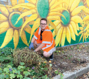 Kentucky Colonel volunteer digging weeds up.